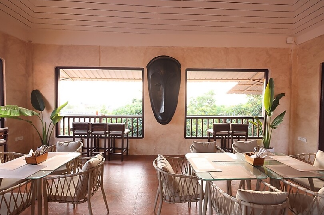 Dining room with cane chairs and a view to the trees