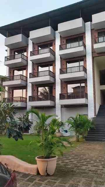 Laterite guest block with stacked balconies